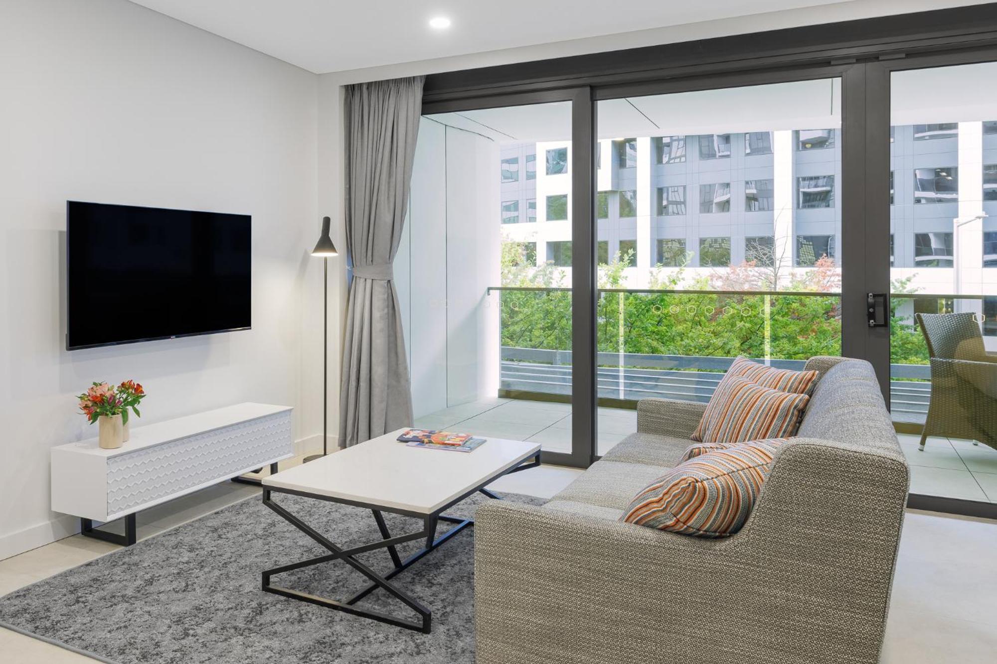 Meriton Suites Camberra Exterior foto Living room